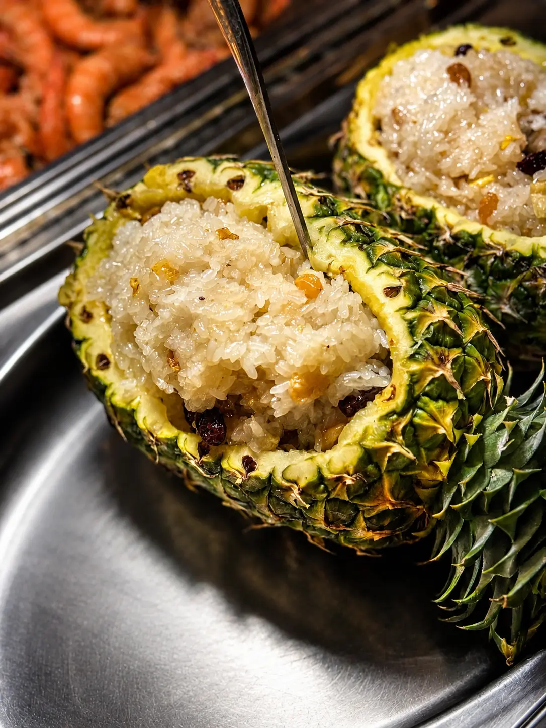 Pineapple fried rice served in a hollowed pineapple half at Royal Buffet & Grill