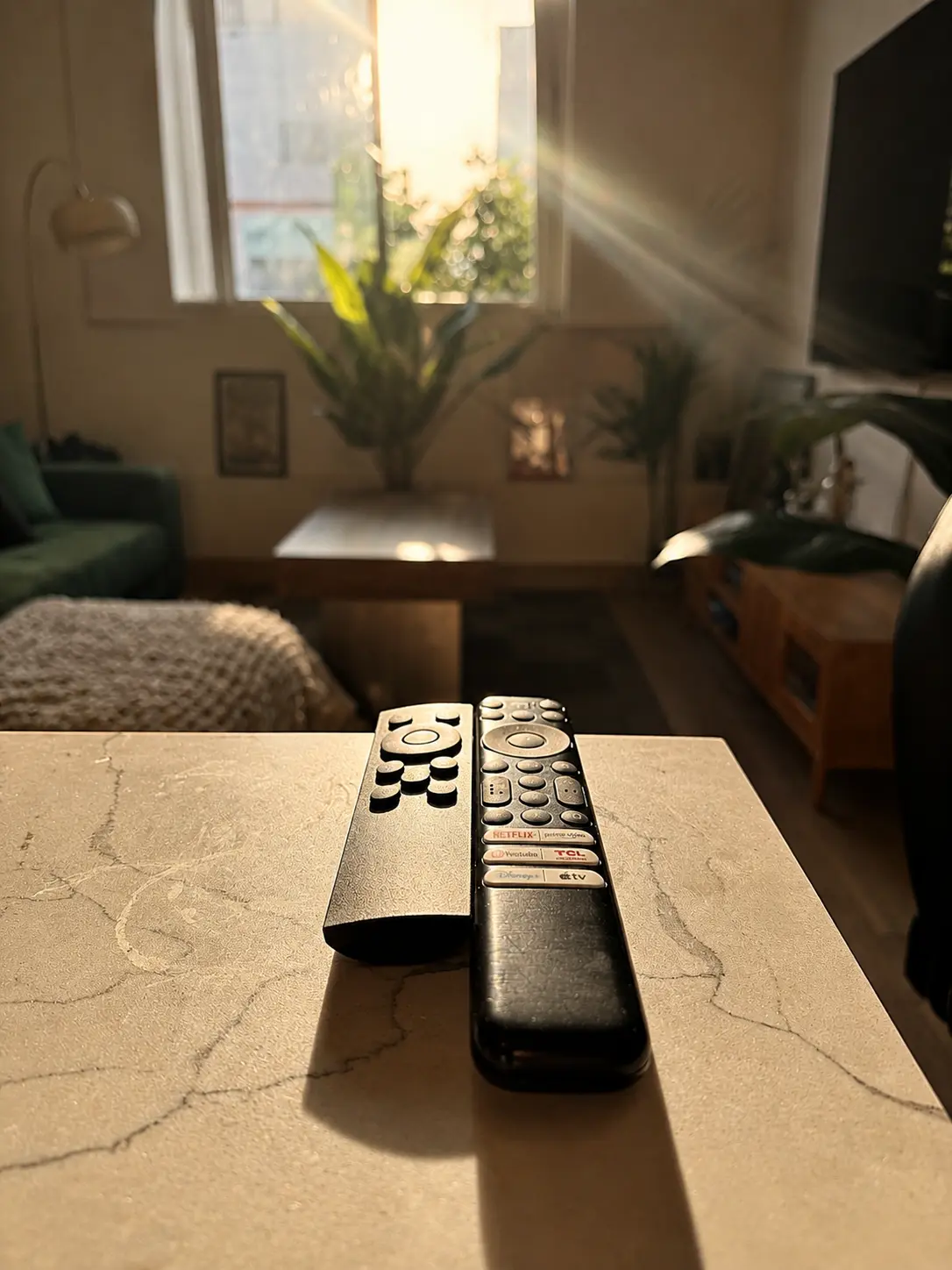 Remotes and small objects arranged on a side table at Alexander Residence