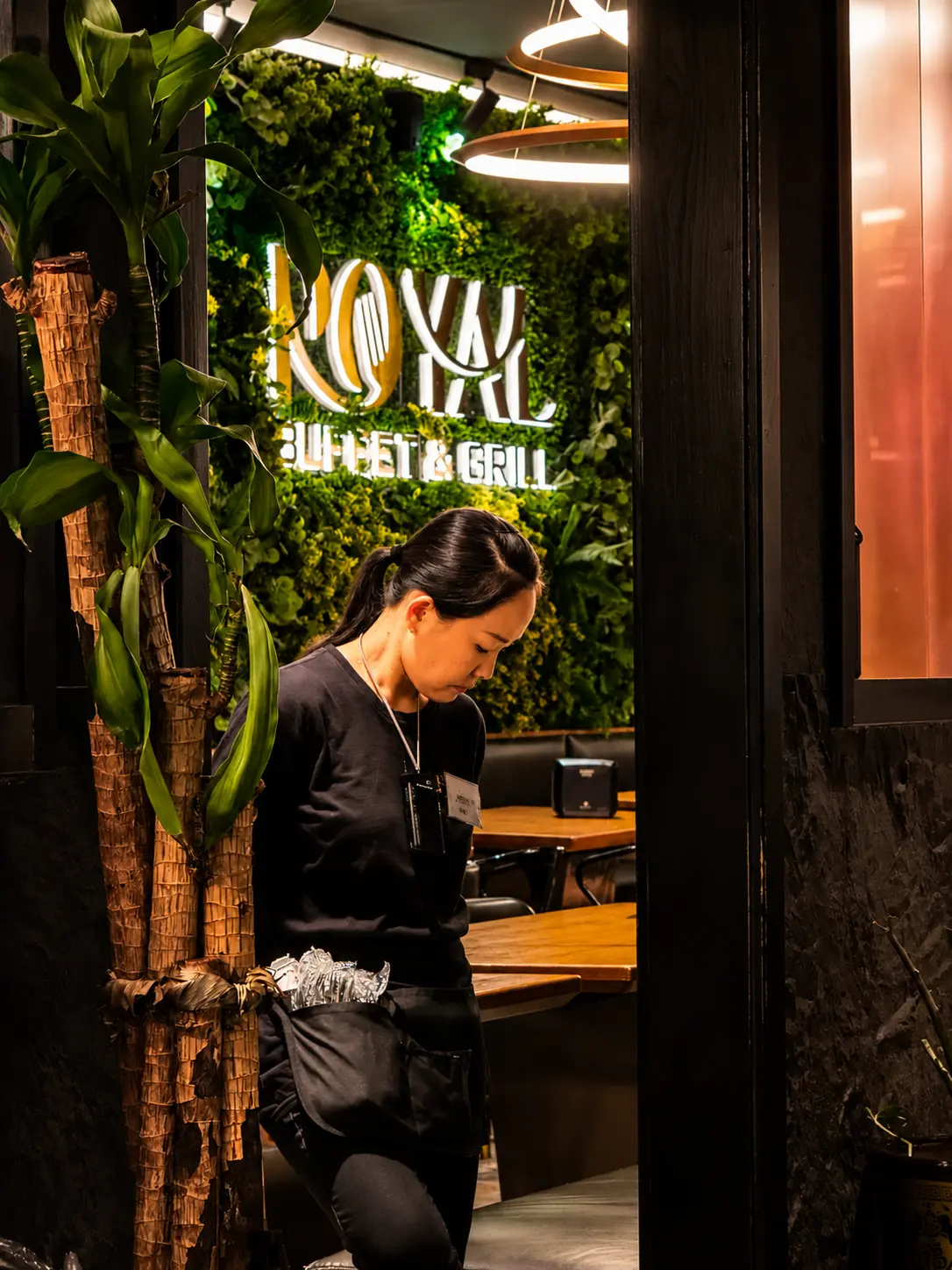 A staff member at the counter beneath the Royal Buffet & Grill sign in South Philadelphia