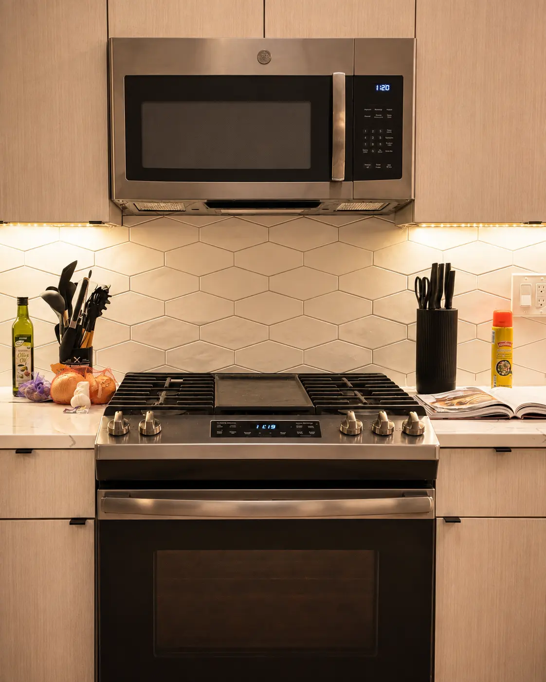 The kitchen at Alexander Residence seen in full, daylight falling across the counter